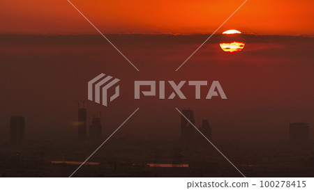 Sunrise over greens and al barsha heights district area night to day timelapse from Dubai marina. Sunrise over greens and al barsha heights district area night to day timelapse from Dubai marina. 100278415