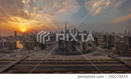 Sunset over panoramic skyline of Dubai with business bay and downtown district timelapse. 100278455