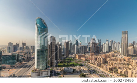 Panorama showing Dubai's business bay towers aerial morning timelapse. Rooftop view of some skyscrapers Panorama showing Dubai's business bay towers aerial morning timelapse. Rooftop view of some skyscrapers 100278496