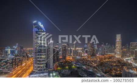 Panorama showing Dubai's business bay towers aerial night timelapse. Rooftop view of some skyscrapers Panorama showing Dubai's business bay towers aerial night timelapse. Rooftop view of some skyscrapers 100278503