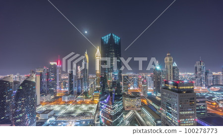 Panorama of futuristic skyscrapers in financial district business center in Dubai all night timelapse Panorama of futuristic skyscrapers in financial district business center in Dubai all night timelapse 100278773