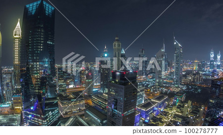 Panorama of futuristic skyscrapers in financial district business center in Dubai night timelapse Panorama of futuristic skyscrapers in financial district business center in Dubai night timelapse 100278777