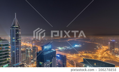 Aerial skyline with Golf Club, hotels and residential areas far away in desert in Dubai all night timelapse, UAE, top view Aerial skyline with Golf Club, hotels and residential areas far away in desert in Dubai all night timelapse, UAE, top view 100278858