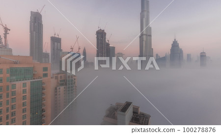 Aerial view of Dubai city early morning during fog night to day timelapse. Aerial view of Dubai city early morning during fog night to day timelapse. 100278876