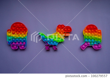 Trendy pop it and simpl dimple toys in form of dinosaur, and a character among us on a Very Peri background 100279557