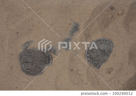 coin in sand under the water coin in sand under the water 100280012