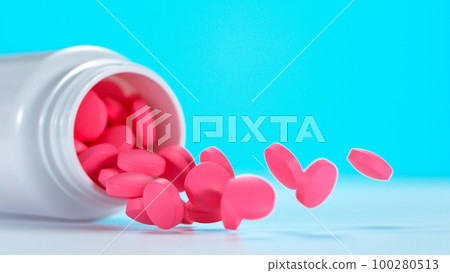 Freeze motion of falling pills on blue background. 100280513