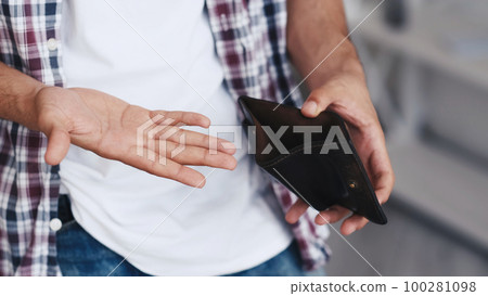 Money loss. No savings. Poverty privation. Unemployment crisis. Unrecognizable bankrupt penniless broke man hands showing empty wallet. Money loss. No savings. Poverty privation. Unemployment crisis. Unrecognizable bankrupt penniless broke man hands showing empty wallet. 100281098