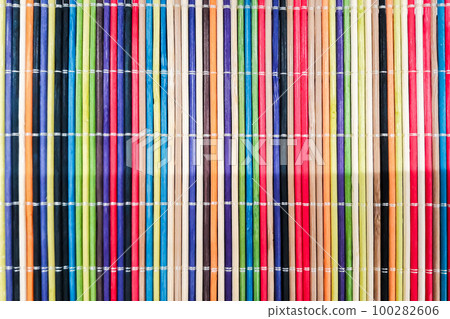 Multi colored wooden mat closeup. Abstract texture. 100282606