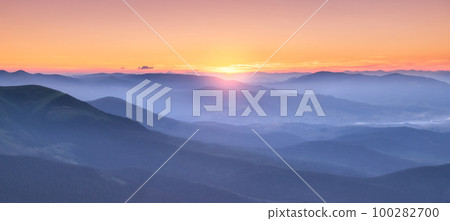 Amazing silhouettes of a mountains at colorful sunset in summer 100282700