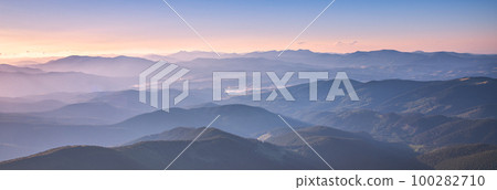 Amazing silhouettes of a mountains at colorful sunset in summer Amazing silhouettes of a mountains at colorful sunset in summer 100282710