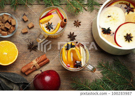 Aromatic mulled wine on wooden table, flat lay Aromatic mulled wine on wooden table, flat lay 100283987