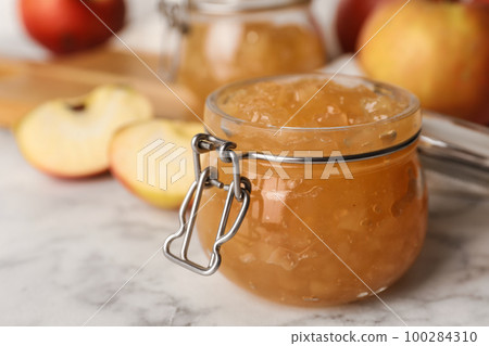 Delicious homemade apple jam on marble table Delicious homemade apple jam on marble table 100284310