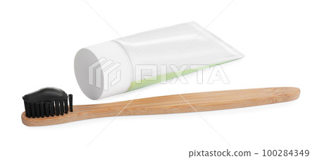 Bamboo toothbrush with charcoal paste isolated on white 100284349