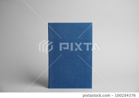 Hardcover book on light grey background. Space for design 100284376