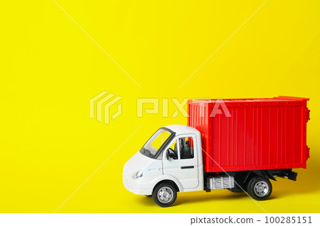 Toy truck on yellow background, space for text. Logistics and wholesale concept 100285151