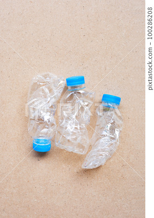 Plastic bottles on brown background. Plastic bottles on brown background. 100286208