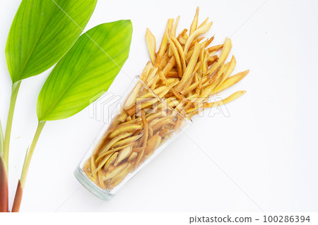 Sliced finger root in glass on white background. Sliced finger root in glass on white background. 100286394