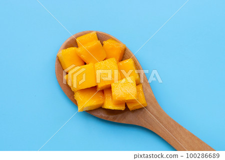 Tropical fruit, Mango cube slices on blue background. Tropical fruit, Mango cube slices on blue background. 100286689