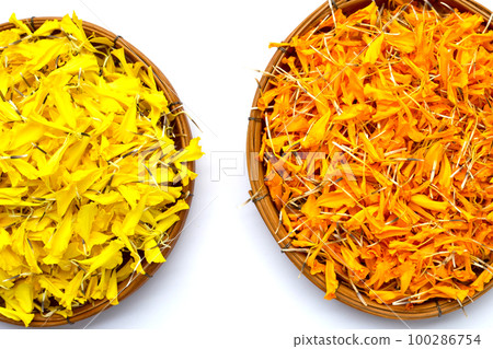 Marigold flower petals in bamboo weave plate on white background. Marigold flower petals in bamboo weave plate on white background. 100286754