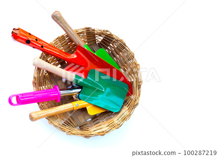 Garden shovel with fork in bamboo basket on white background. Garden tools Garden shovel with fork in bamboo basket on white background. Garden tools 100287219