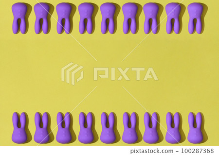 Top view of many violet dildo vibrators for clitoris on yellow background. Sex toys for adult 100287368