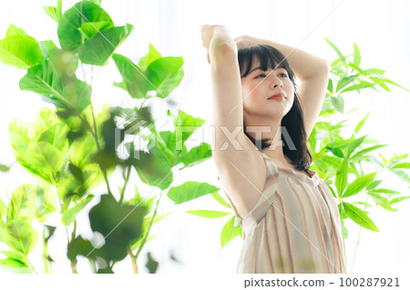 Woman surrounded by greenery Botanical image of beauty 100287921