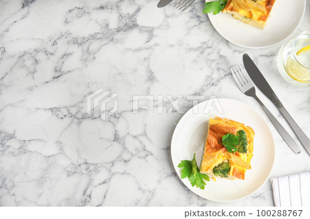 Tasty broccoli casserole served on white marble table, flat lay. Space for text Tasty broccoli casserole served on white marble table, flat lay. Space for text 100288767