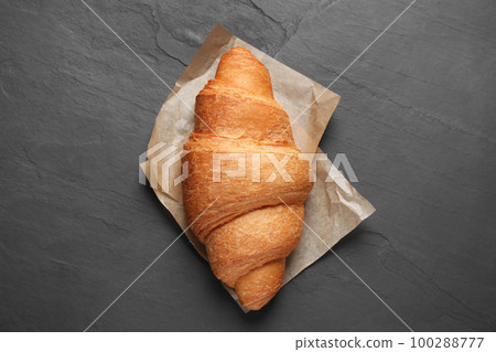 Tasty fresh croissant on black table, top view Tasty fresh croissant on black table, top view 100288777