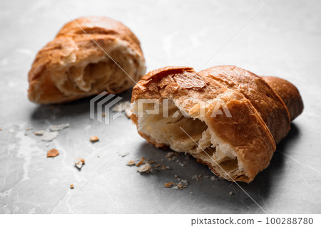 Tasty fresh croissant on light grey marble table, closeup Tasty fresh croissant on light grey marble table, closeup 100288780