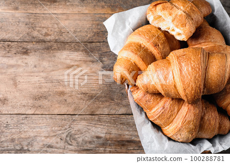 Tasty fresh croissants on wooden table, top view. Space for text Tasty fresh croissants on wooden table, top view. Space for text 100288781