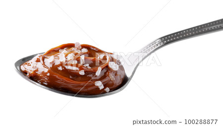 Salted caramel in spoon isolated on white 100288877