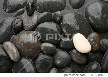 Spa stones in water as background, top view. Zen lifestyle Spa stones in water as background, top view. Zen lifestyle 100288963