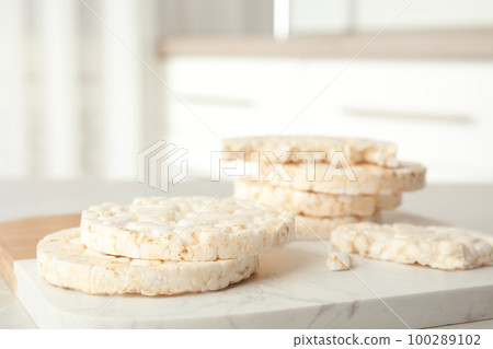 Puffed rice cakes on board indoors, closeup. Space for text Puffed rice cakes on board indoors, closeup. Space for text 100289102