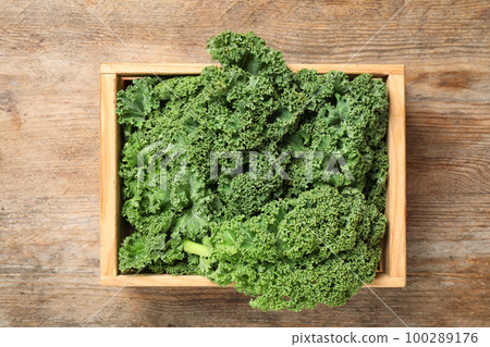 Fresh kale leaves on wooden table, top view Fresh kale leaves on wooden table, top view 100289176