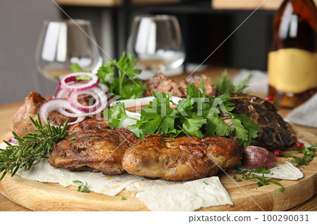 Delicious roasted chicken tobacco with herbal on wooden board, closeup 100290031