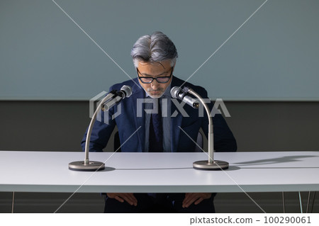 A man with gray hair who looks like an apology interview A man with gray hair who looks like an apology interview 100290061
