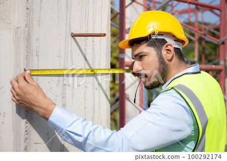Engineer young man using tape measure for check and examining length of structure. Engineer young man using tape measure for check and examining length of structure. 100292174