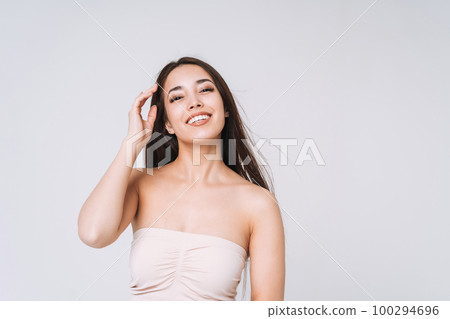 Beauty portrait of asian woman with healthy dark long hair in top bando on white background isolated 100294696