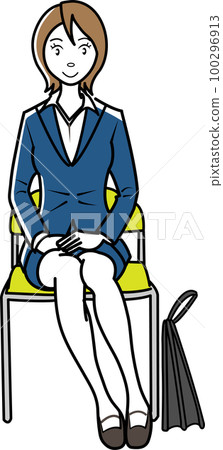 A woman in a suit sitting on a chair A woman in a suit sitting on a chair 100296913