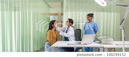 Young asian woman consulting about cosmetic surgeon and make botox injections on face for beauty procedures. Atmosphere at cosmetic surgery department in hospital clinic. 100299152