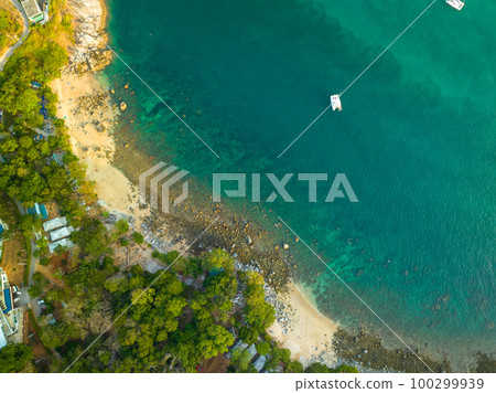 aerial top view Ao Sean small white sand beach lined with rocks. turquoise sea at Ao Sane beach Phuket. colorful blue sea background. beautiful nature in the hidden beach. aerial top view Ao Sean small white sand beach lined with rocks. turquoise sea at Ao Sane beach Phuket. colorful blue sea background. beautiful nature in the hidden beach. 100299939