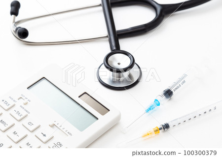 Stethoscope and calculator white background Stethoscope and calculator white background 100300379