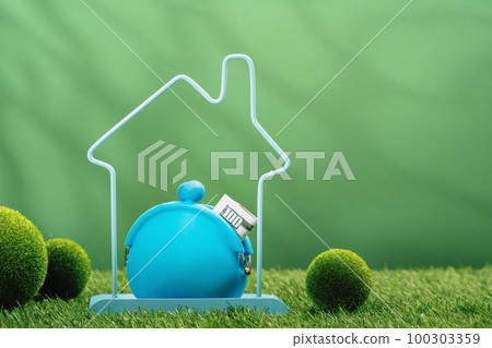 Real estate services cost. House insurance protection and safety. moving and relocation. house frame in green residential area with money purse. Downsizing. Loan for new home. Finding new property 100303359