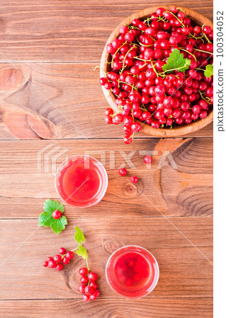 Cold compote made from fresh red currant berries. Boiled redcurrant juice. Top view Cold compote made from fresh red currant berries. Boiled redcurrant juice. Top view 100304052
