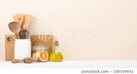 Kitchen utensils on wooden table Kitchen utensils on wooden table 100304642