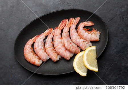 Shrimps on plate with lemon 100304792