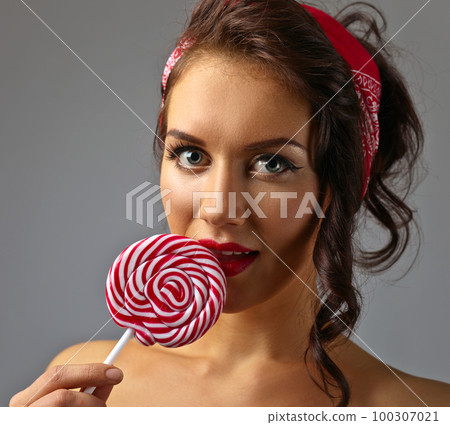young beautiful woman with candy 100307021