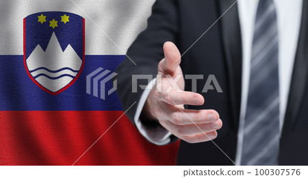 Slovenian business, politics, cooperation and travel concept. Hand on flag of Slovenia background. 100307576
