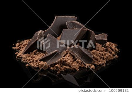 Pile of Cocoa powder and chocolate pieces isolated on black background 100309181